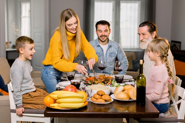 Beautiful happy family, grandfather, parents and children, celebrating thanksgiving day together