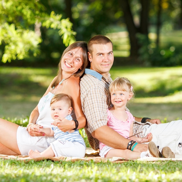 Beautiful happy family resting in the park