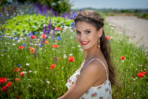 Beautiful happy female in the wildflowers