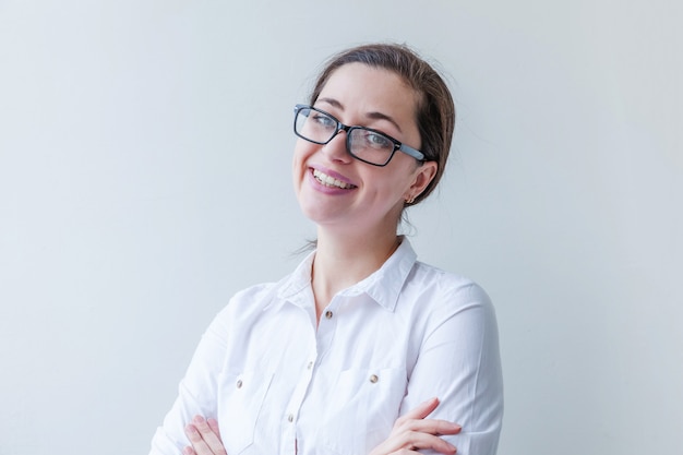 Beautiful happy girl smiling. Beauty simple portrait young smiling brunette woman in eyeglasses isolated