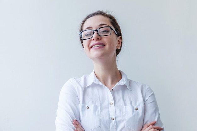 Beautiful happy girl smiling. Portrait of young woman in eyeglasses isolated on white background. Positive human emotion facial expression body language.