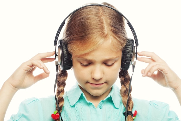 Beautiful happy little girl with headphones