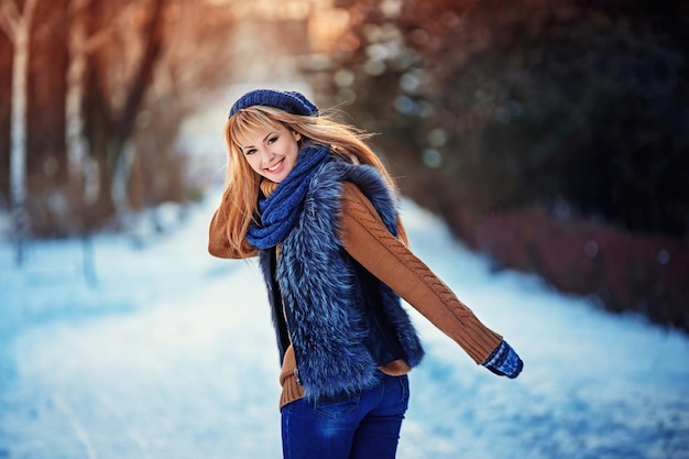 Beautiful happy smiling girl wearing sweater knitted hat and gloves young woman feeling happy and