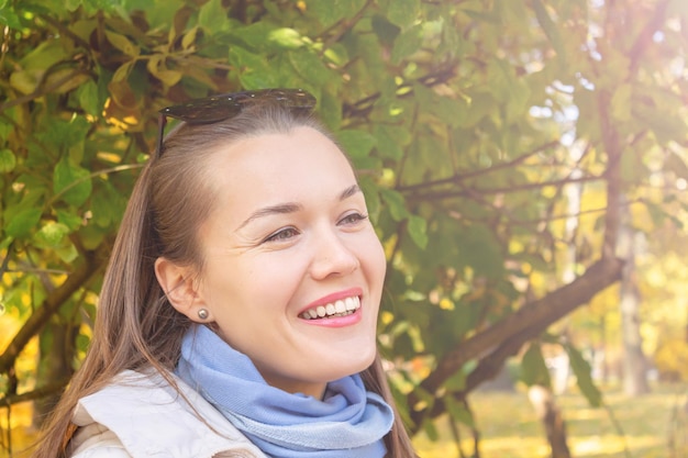 Beautiful happy smiling woman in autumn park