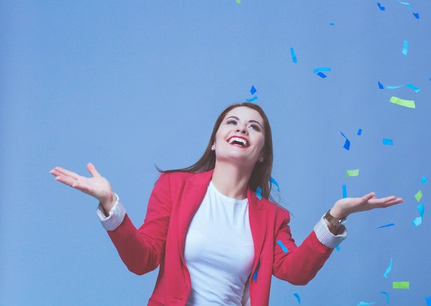 Beautiful happy woman at celebration party with confetti Birthday or New Year eve celebrating concept