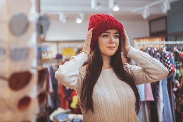 Beautiful happy woman enjoying shopping at clothing store