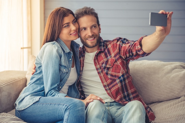 Beautiful happy young couple is doing selfie.