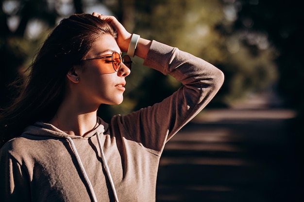 Beautiful happy young woman in sunglasses laughing in the park happiness