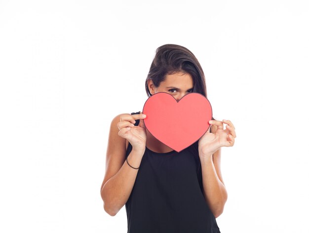 Beautiful happy young woman who is holding a big red heart for valentine's day