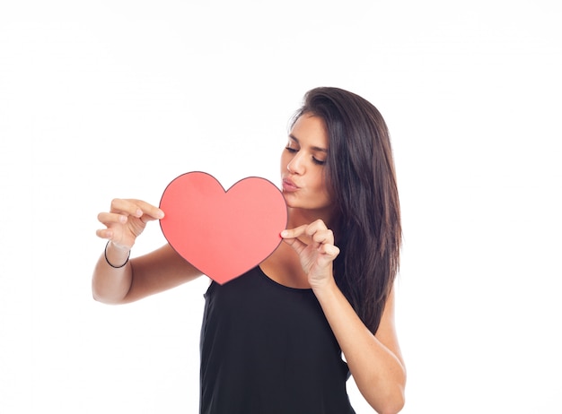 Beautiful happy young woman who is holding a big red heart for valentine's day