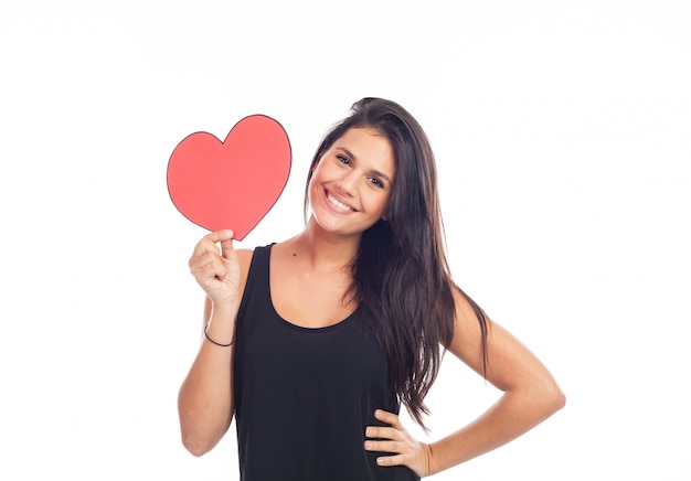 Beautiful happy young woman who is holding a big red heart for valentine's day