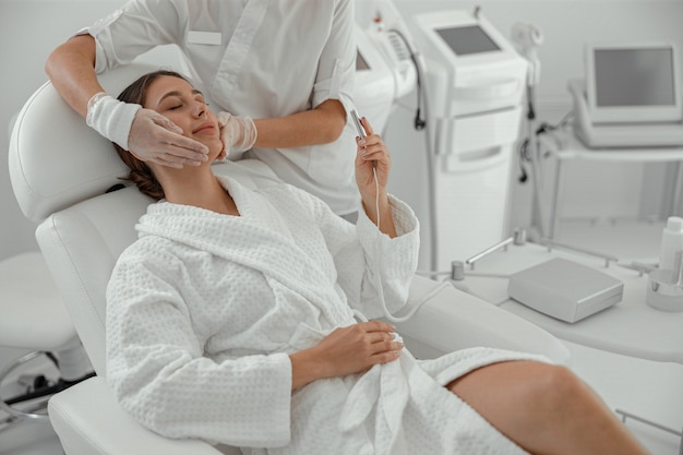 Beautiful healthy smiling caucasian woman is doing beauty procedures at spa and healthcare salon