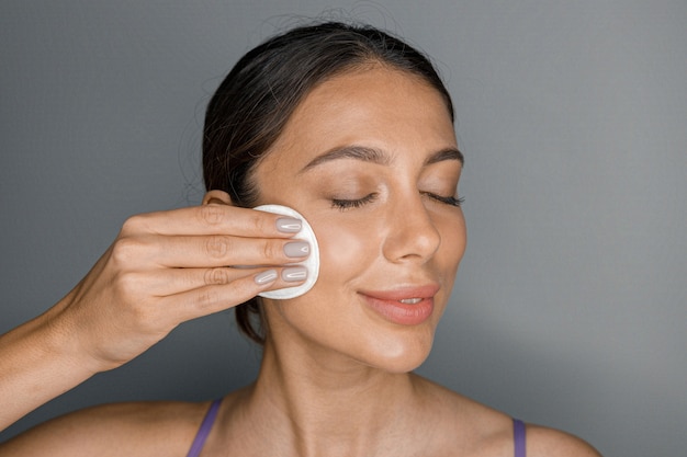 Beautiful healthy smiling caucasian woman is doing beauty procedures at spa and healthcare salon