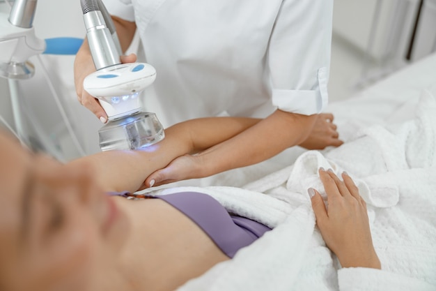 Beautiful healthy smiling caucasian woman is doing beauty procedures at spa and healthcare salon