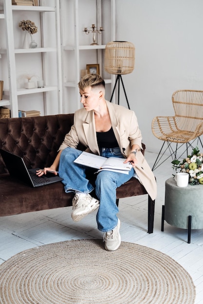 Beautiful hipster woman in casual cloth using laptop at home cheerful woman using laptop