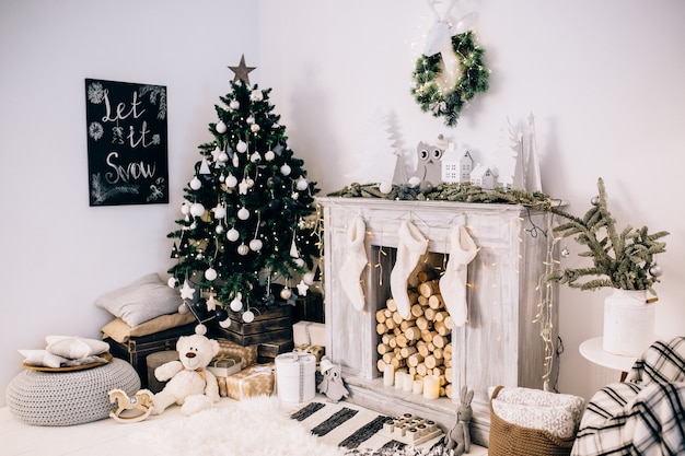 Beautiful holdiay decorated room with Christmas tree with presents under it