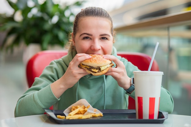 Beautiful hungry young woman with appetite