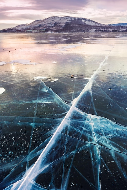 Beautiful ice on the lake at sunset. Winter landscape