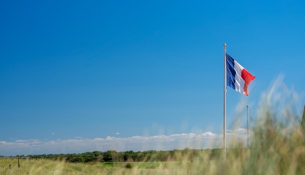 Beautiful image with French flag raised against sky