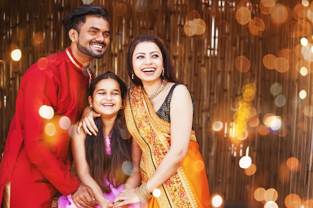 beautiful indian family in traditional ethnic clothes with little girl