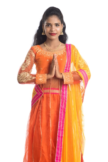 Beautiful Indian girl with welcome expression inviting or greeting Namaste