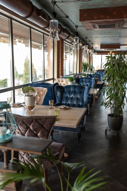 Beautiful interior of the restaurant in semiantique dark brown shades Served tables