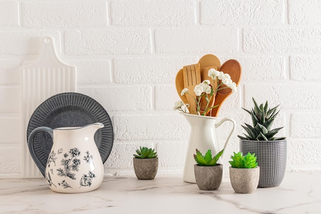 Beautiful kitchen background in gray and white tones with kitchen utensils and utensils White brick wall in the modern interior of the kitchen