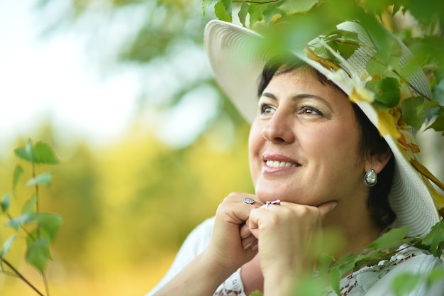 Beautiful   lady in hat enjoying summer outdoors