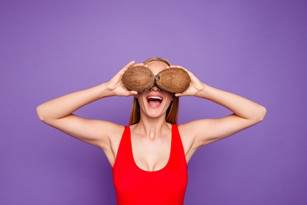 beautiful lady having party covering her eyes with coconuts