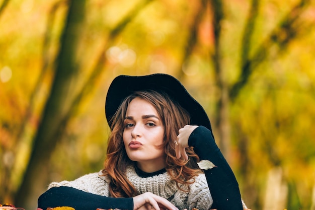 Beautiful lady with flowing hair and in black hat