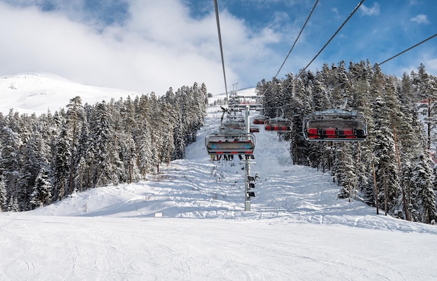 Beautiful landscape of the Arkhyz ski resort with mountains rorest snow and a cable car on a sunny winter day Caucasus Mountains Russia