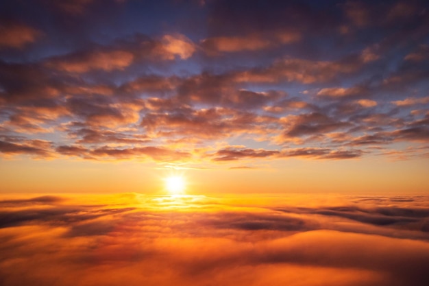 Beautiful landscape above the clouds of setting sun Aerial photo of sun going under horizon dream like atmosphere