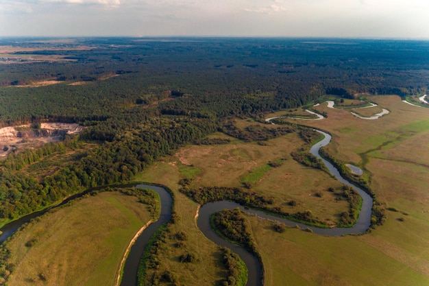 Beautiful landscape of the European plain with fields and a snaking river