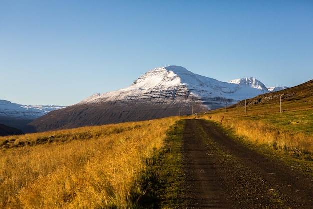 Beautiful landscape image of Iceland with mountains blue sky and green grass