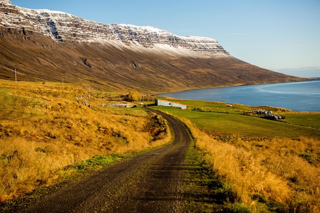 Beautiful landscape image of Iceland with mountains blue sky and green grass