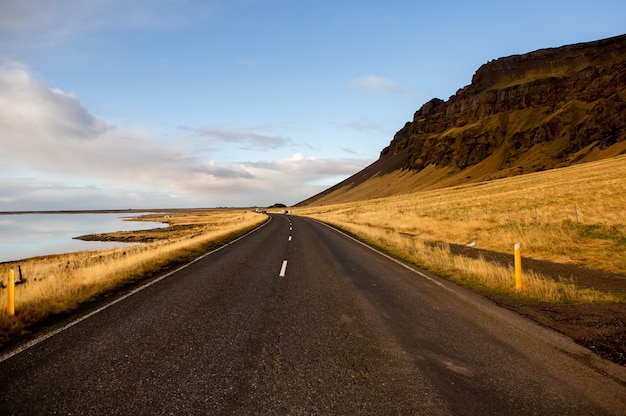 Beautiful landscape image of Iceland with mountains blue sky and green grass