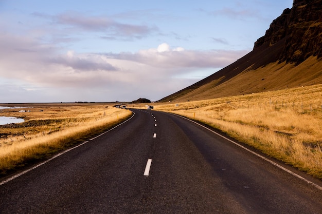 Beautiful landscape image of Iceland with mountains blue sky and green grass