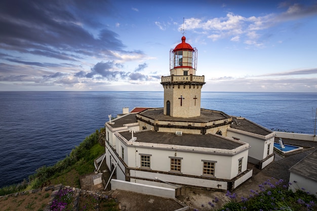 Beautiful landscape of the lighthouse of Ponta do Arnel with the sea in the background