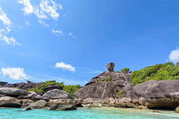 Beautiful landscape people on rock is a symbol of Similan Islands, blue sky and cloud over the sea during summer at Mu Ko Similan National Park, Phang Nga province, Thailand