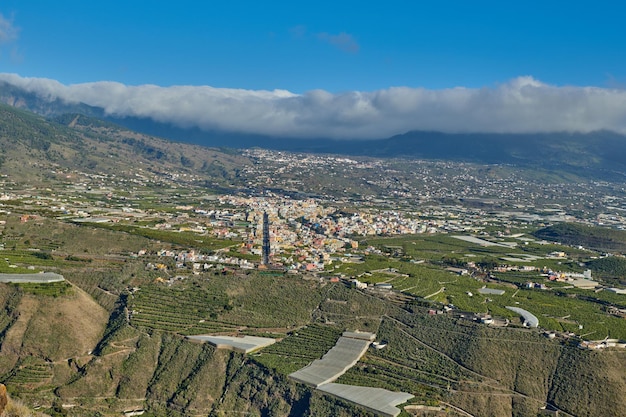 Beautiful landscape of a small agricultural village on a sunny afternoon near a highway or busy road for logistics or transport of goods Banana plantations in the town of Los Llanos La Palma Spain