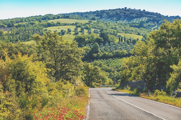 Beautiful landscape spring nature Road among sunny fields in Tuscany Italy