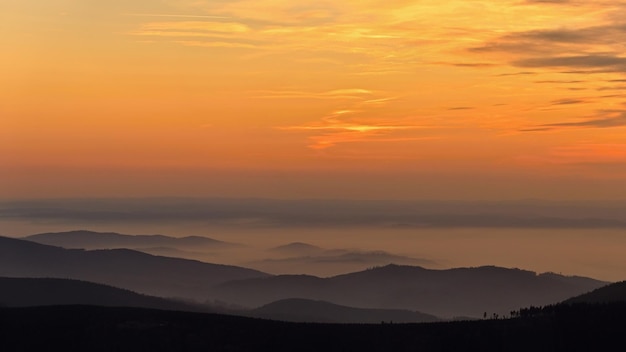 Beautiful landscape and sunset in the mountains Hills in clouds Jeseniky Czech Republic Europe