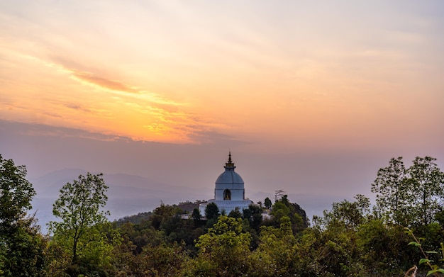 Beautiful landscape view of gloomy Sunrise and world peace stupa at Pokhara Nepal