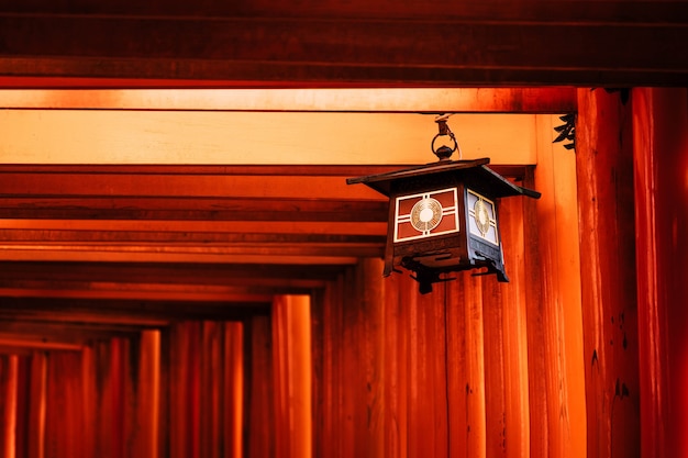 Beautiful lantern decoration on orange red torii gates at Fushimi Inari Taisha Shrine in Kyoto, Japan