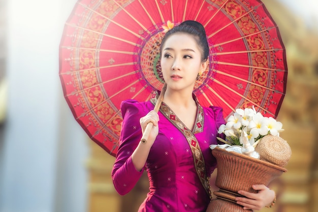 Beautiful Laos girl in Laos traditional costume, vintage style at Vientiane, Laos. 