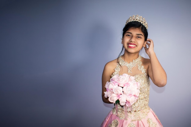 Beautiful latin woman dressed - pink princess costume. blur background with space for text