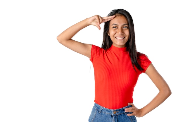 Beautiful Latin woman looking forward waving with her hand on her forehead and with a happy attitude on a pure white background. 