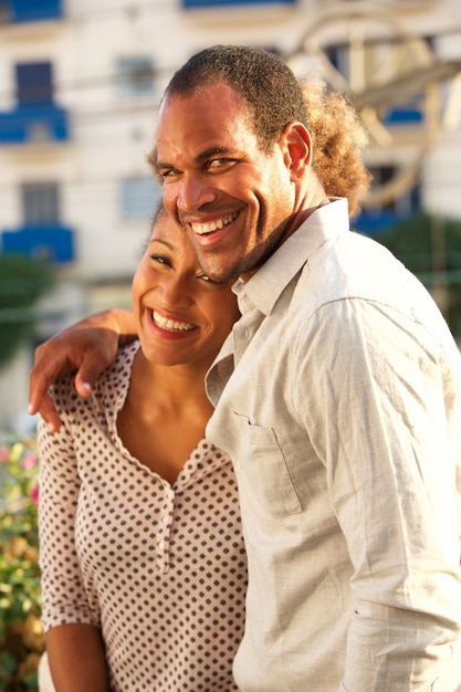 Beautiful laughing couple on date walking outside