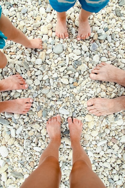 Beautiful legs in the sand of the sea greece background