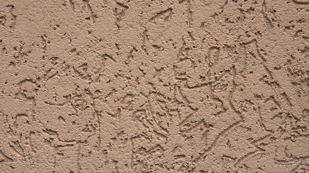 Beautiful light brown texture of concrete wall of the house Decorative plaster